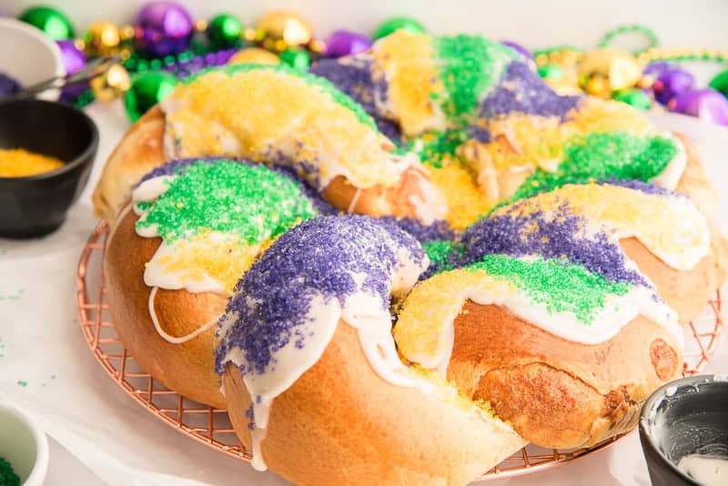Up close image of the side of a decorated King Cake.