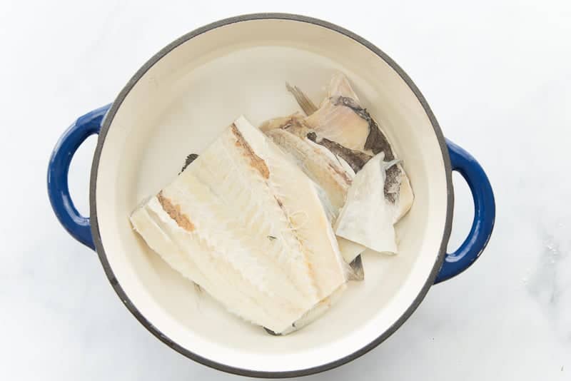 Codfish is covered in cold water to remove the salt.