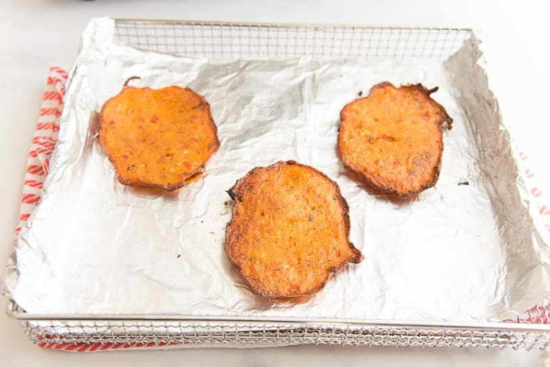 Air-fried bacalaitos on a foil-lined tray.