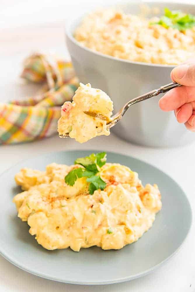 Lead image of a fork holding a bite of Country-Style Potato Salad