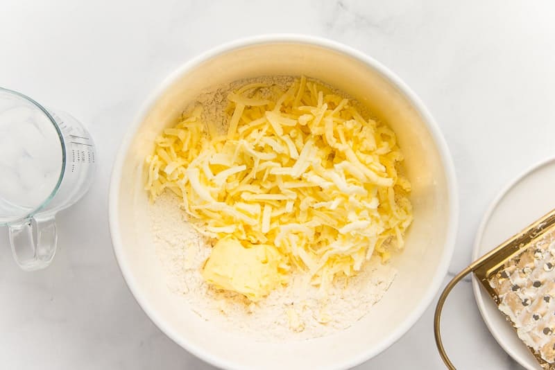Shredded butter and shortening in a bowl with flour