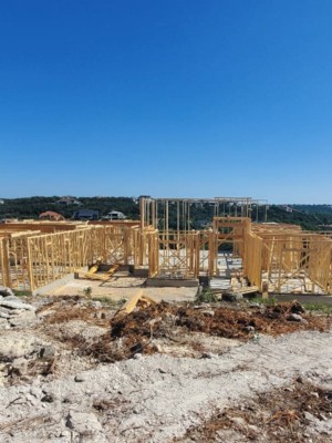 Custom Home Build in the framing stages with blue sky