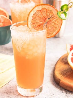 Spicy Paloma preview image highball glass with a dried grapefruit and jalapeño twist garnish