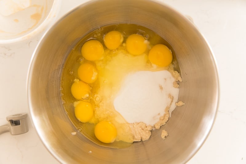 Eggs, sugar, and salt are added to a mixing bowl with the brioche sponge.