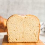 Lead image of a cut loaf of Brioche Bread on a wooden board.