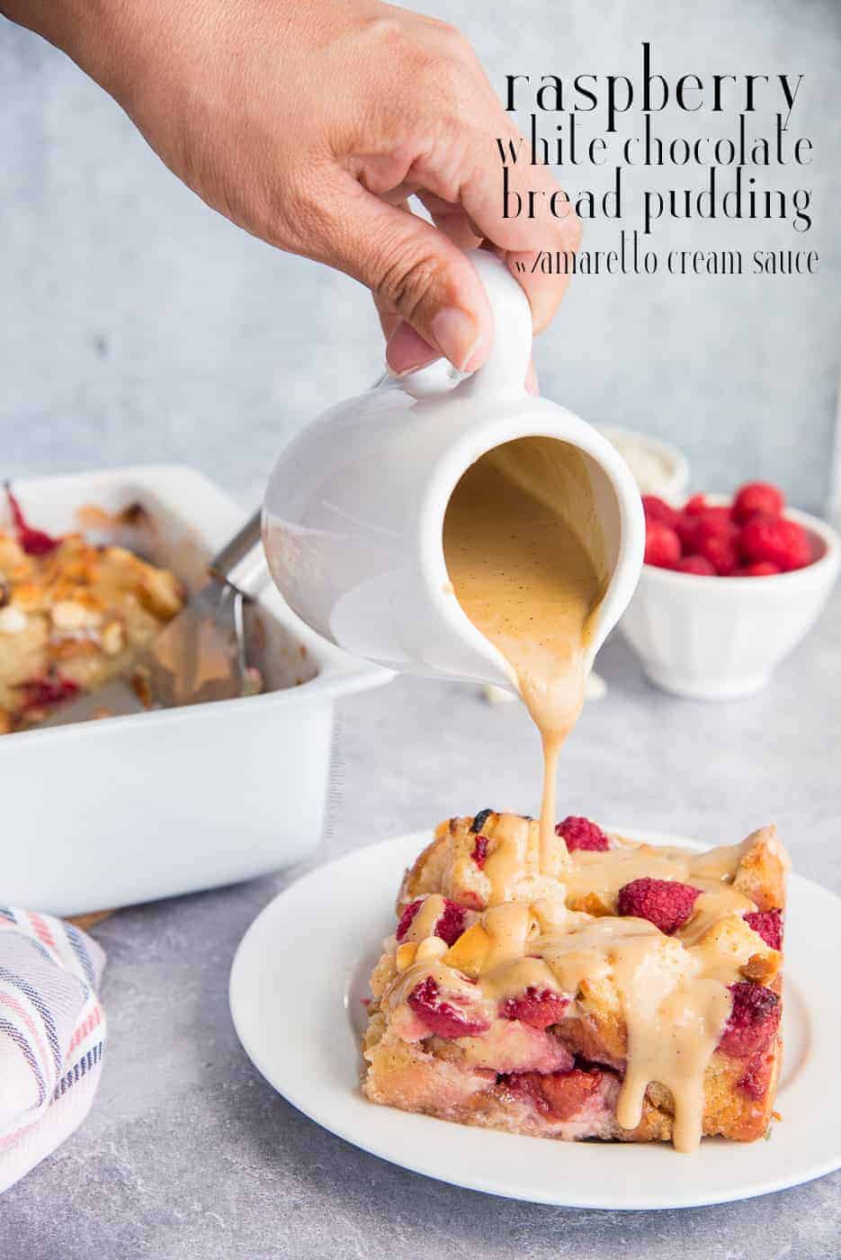 Raspberry White Chocolate Bread Pudding with Amaretto Cream Sauce is a decadent, fruity dessert that is simple to assemble and can bake while you prepare tonight's dinner. Bonus: it also tastes amazing as a breakfast or brunch dish. #raspberrybreadpudding #whitechocolatebreadpudding #breadpudding #breadpuddingrecipe #baking #dayoldbreadrecipe #challah #pansobao #frenchbread #bakingrecipes #whitechocolaterecipes #summerdessert #dessert #brunch #breakfast #breadpuddingdessert #amarettosauce via @ediblesense