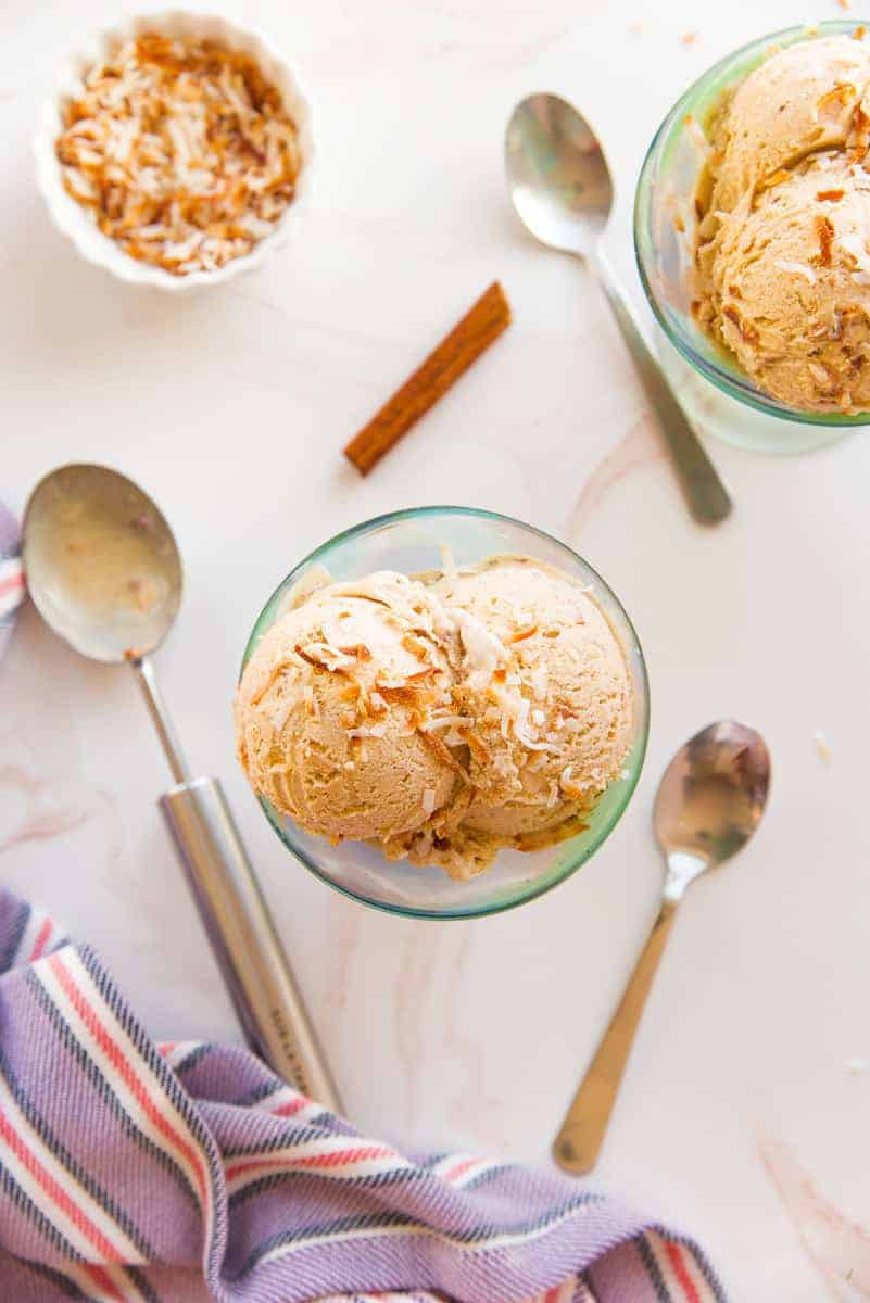 Coquito Frozen Custard lead image two bowls of custard garnished with toasted coconut flakes.