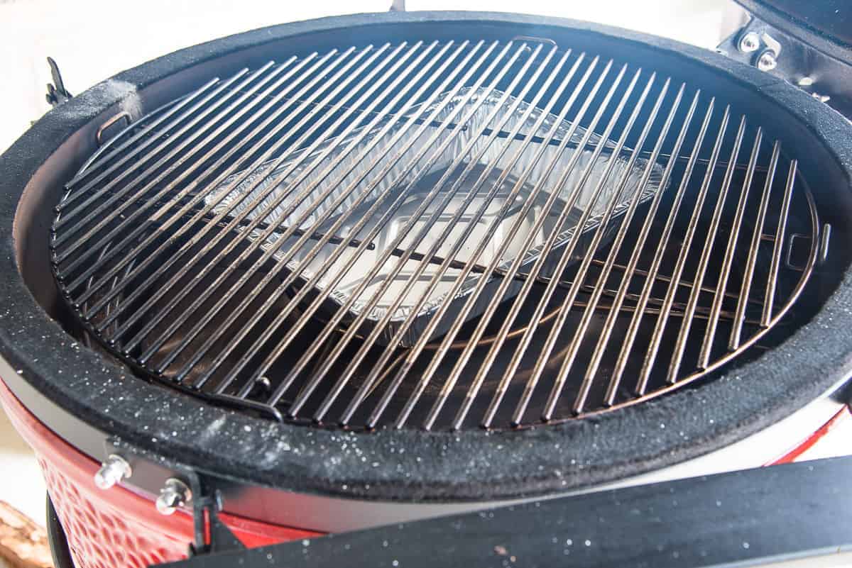 The smoker is prepared with a drip pan which sits under the grates