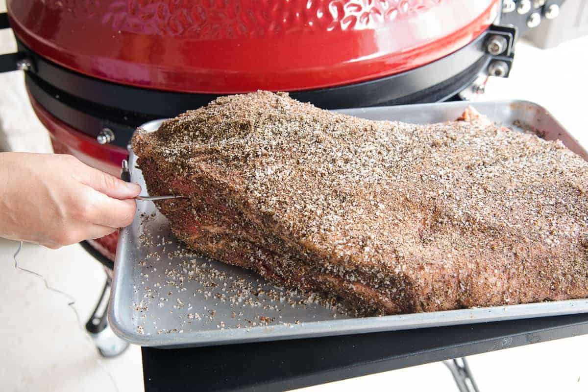 A probe is inserted into the thickest part of the brisket before going on the smoker