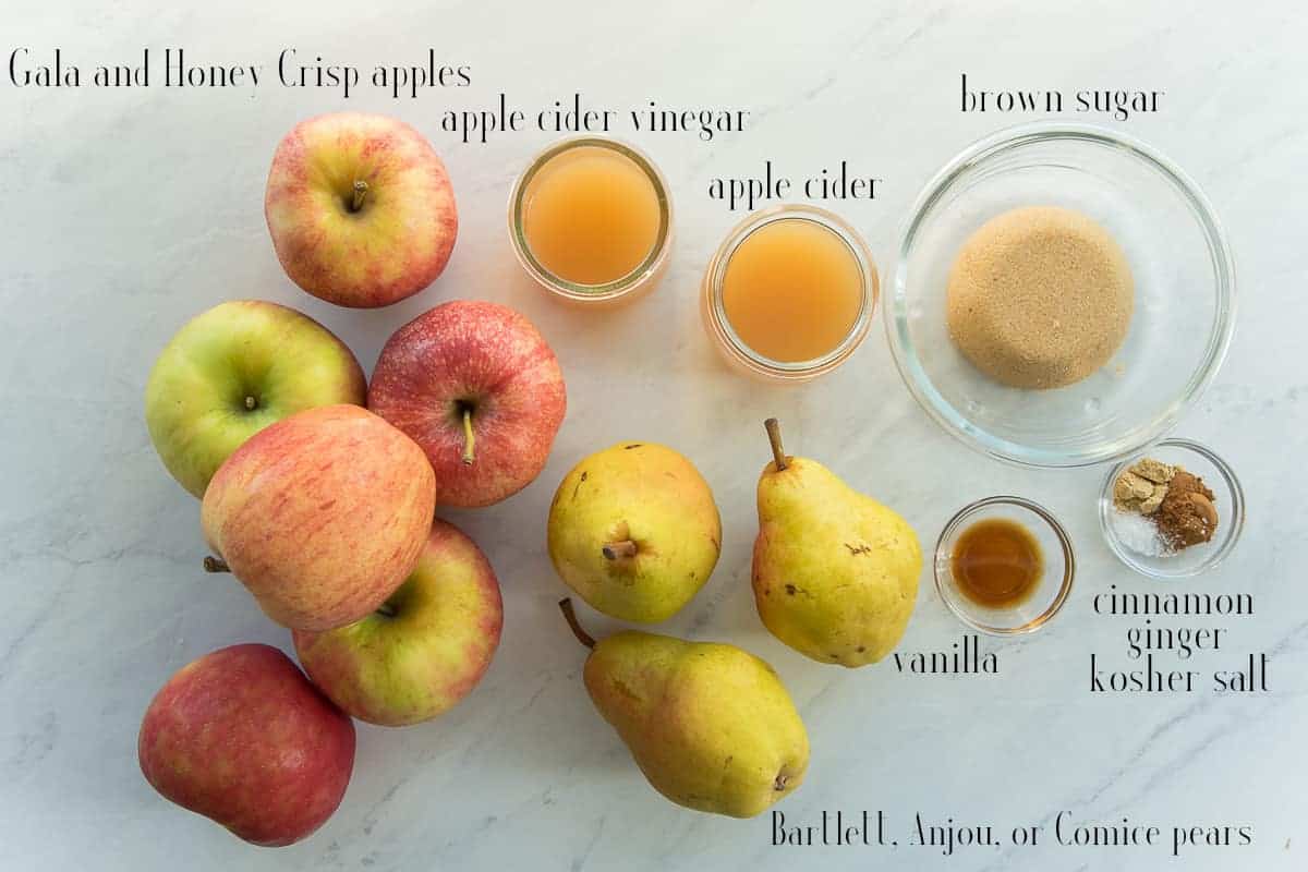 Ingredients to make the Slow Cooker Apple Pear Butter Gala and Honey Crisp Apples, apple cider vinegar, apple cider, brown sugar, cinnamon, ginger, kosher salt, vanilla, Bartlett, Anjou, or Comice pears.