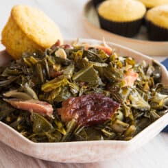 Preview image 2 of a pink bowl of Country Style Collard Greens in the slow cooker with a cornbread muffin.