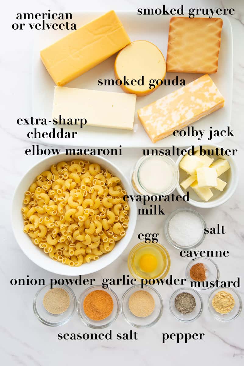 Ingredients to make Five Cheese Baked Macaroni and Cheese on a white countertop.