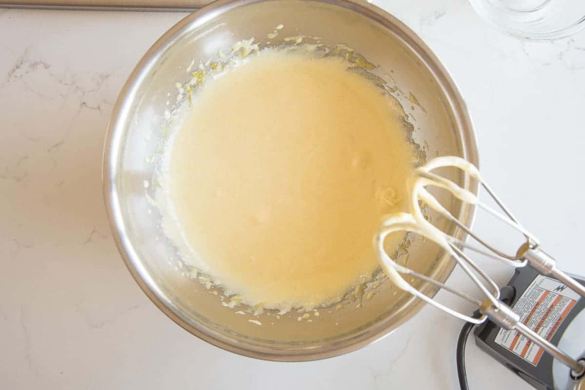 The eggs, sugar, and salt are beaten until lemony yellow and thick.