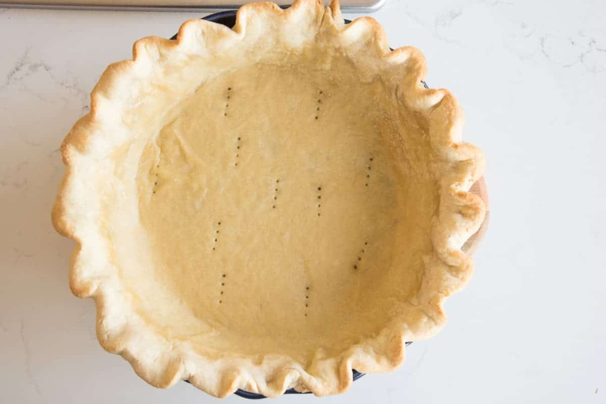 The blind baked pie shell in a horizontal image.