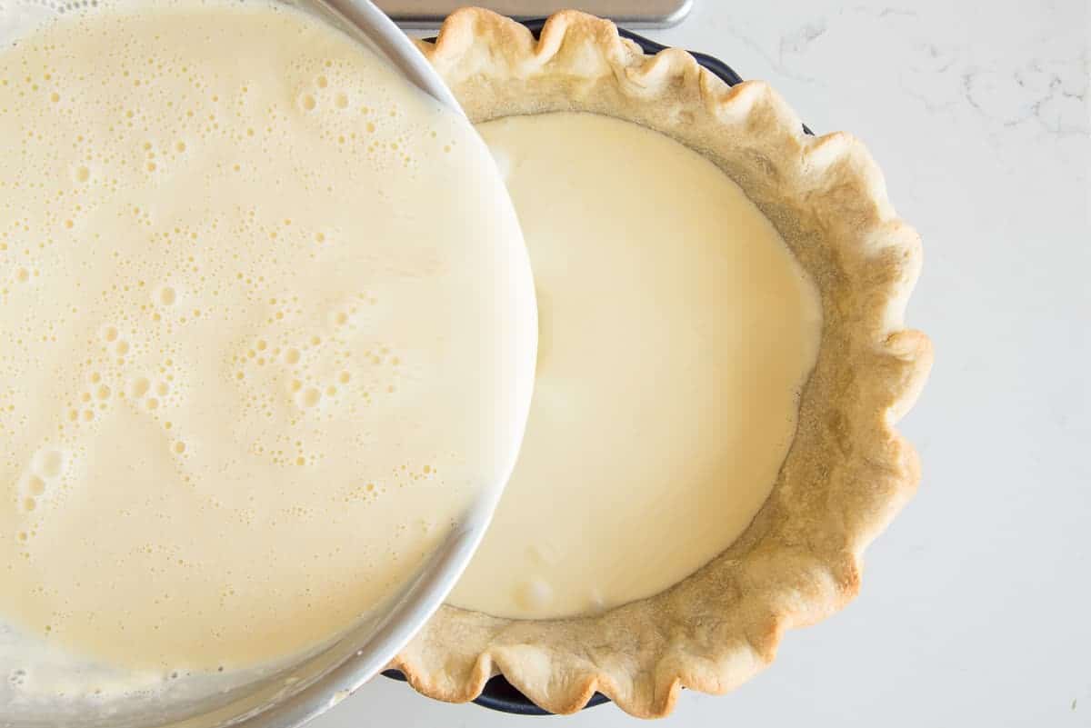 The custard is poured into the blind baked pie shell.