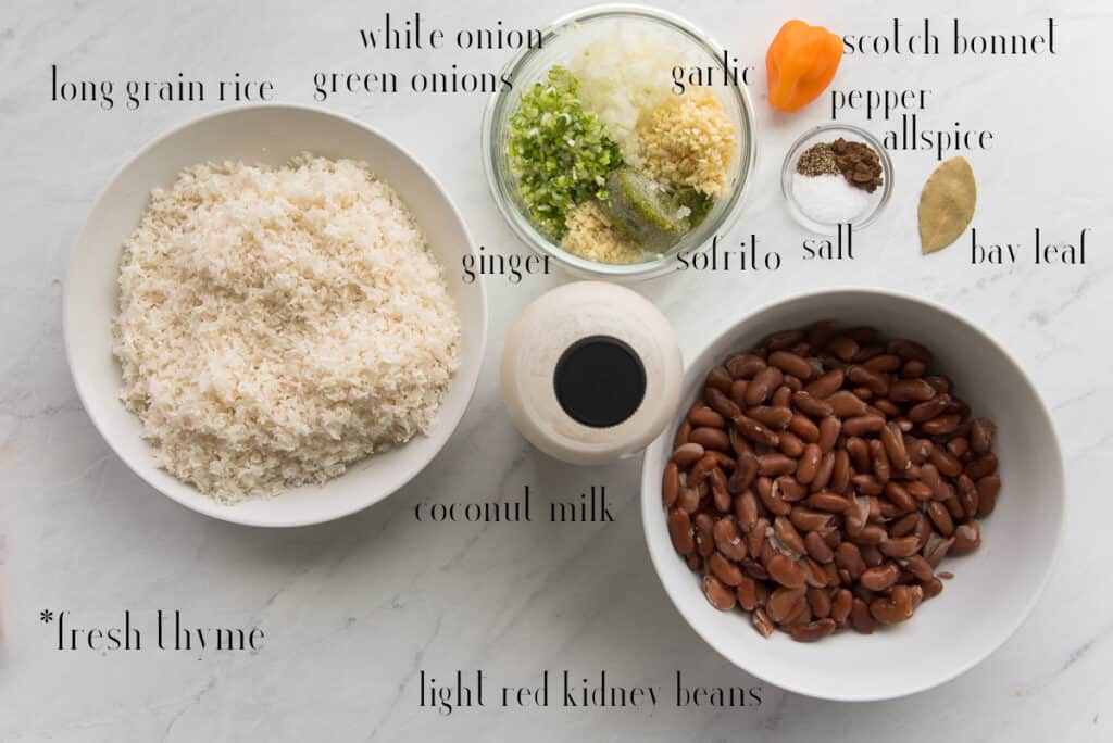 Ingredients to make recipe: rice, white and green onions, garlic, ginger, sofrito, scotch bonnet, pepper, allspice, salt, bay leaf, light red kidney beans, coconut milk, and fresh thyme.