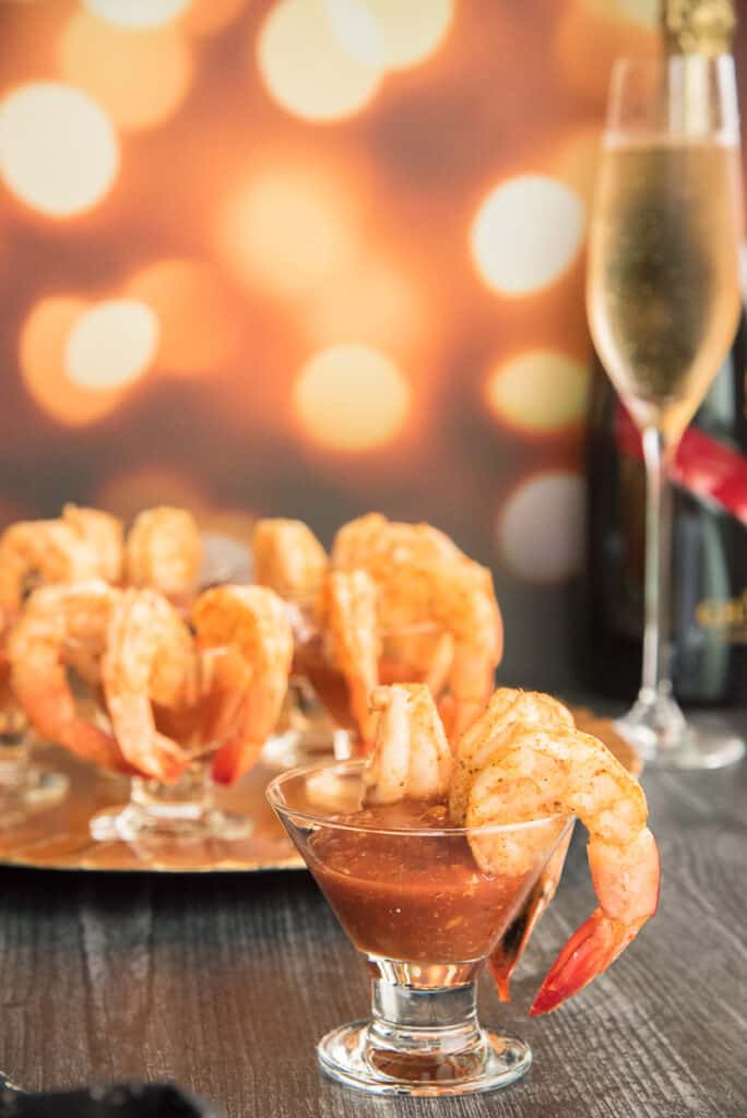 Portrait image of a appetizer glass of Roasted Shrimp Cocktail with Homemade Sauce.
