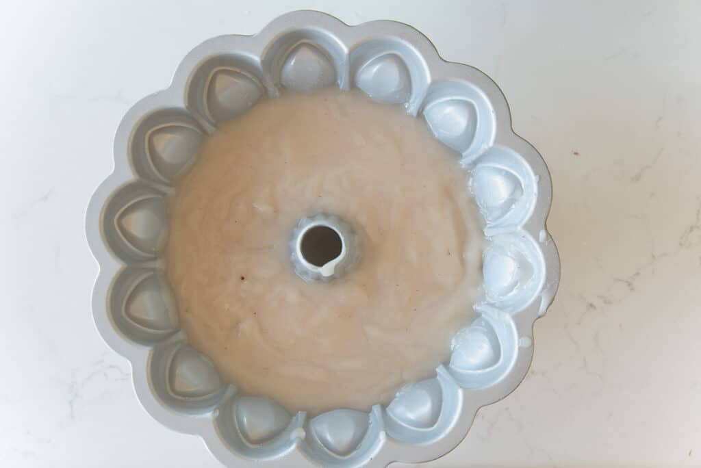 The pudding inside a decorative mold.