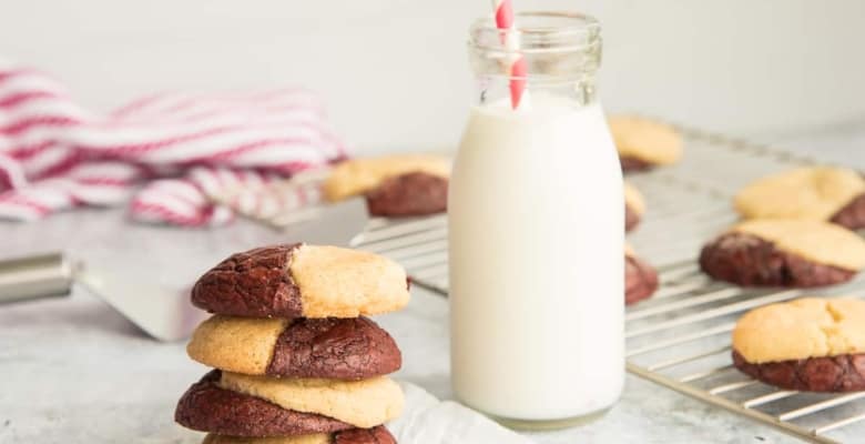 Backup preview image: Horizontal image of a stack of Red Velvet Snickerdoodle Brookies next to a milk bottle with a red and white striped straw in it.