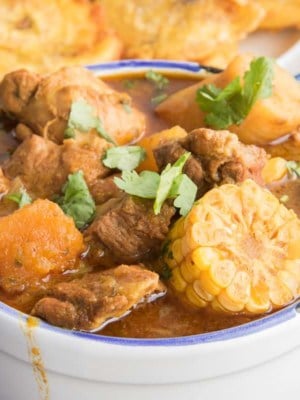 Close-up, horizontal image of a white bowl filled with Sancocho.