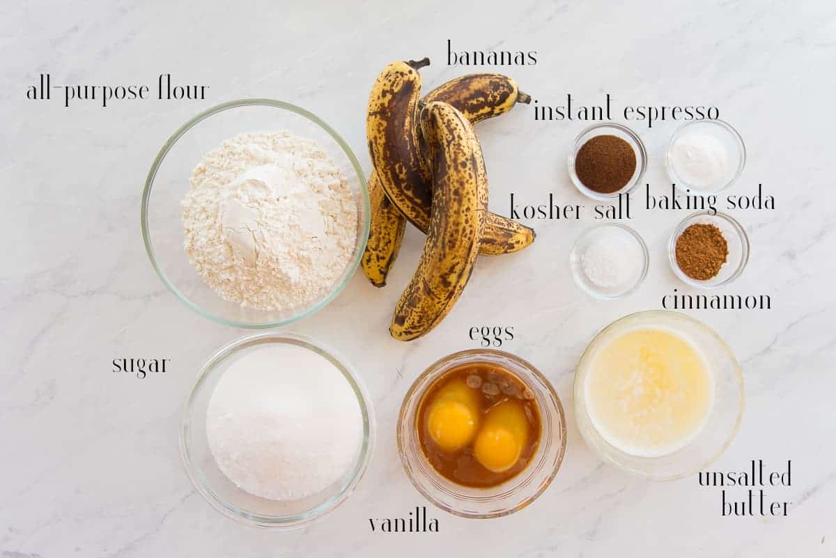The ingredients to make the Banana Bread with Espresso on a white surface.