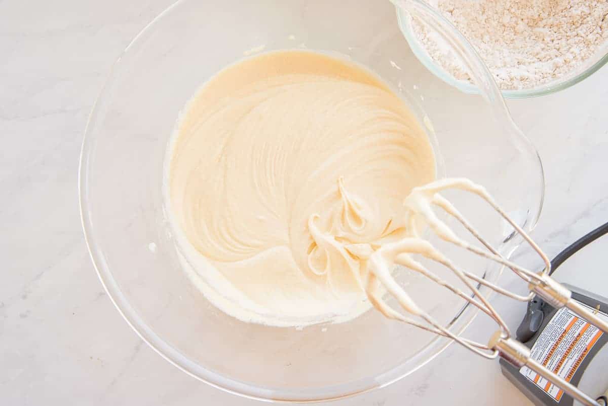 The butter, sugar, and egg mixture is beaten until pale yellow and thick.