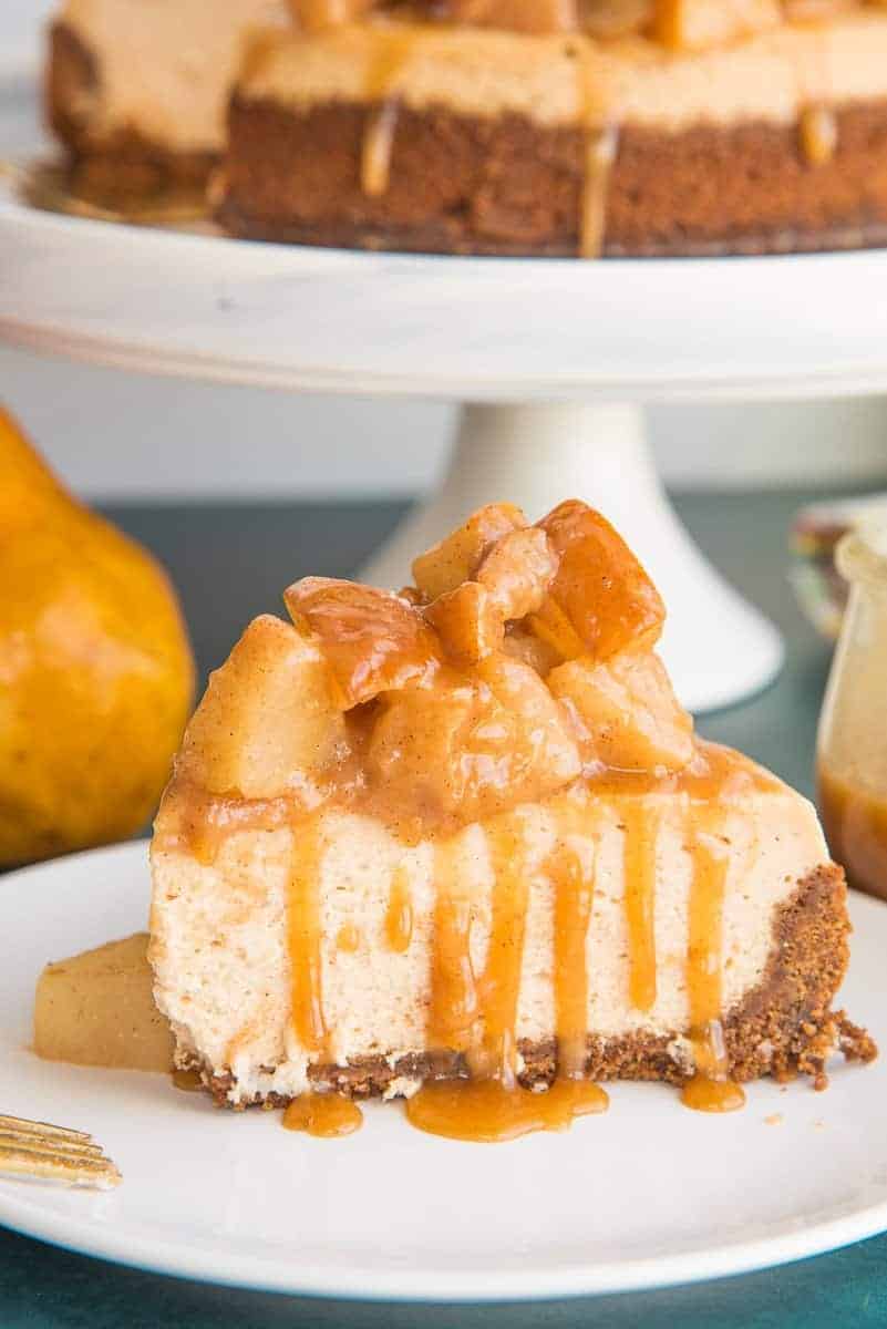 A slice of Cinnamon Cheesecake with Spiced Pear Topping on a white plate