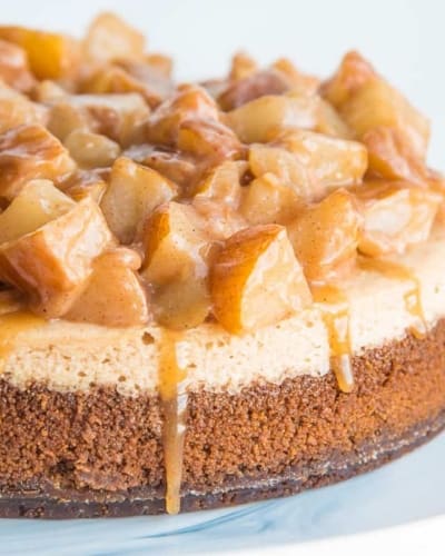 The finished Cinnamon Cheesecake with Spiced Pear Topping with toffee sauce dripping down the side.