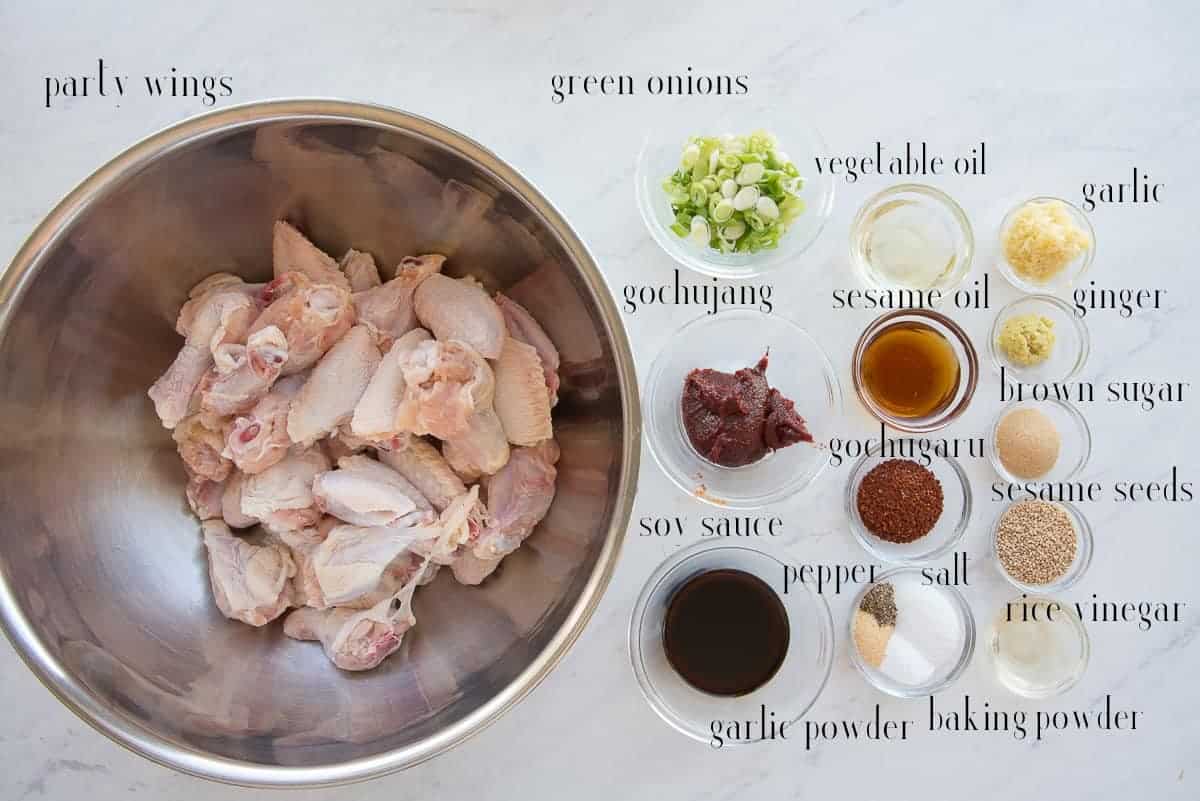 Ingredients to make the Gochujang Air Fryer Chicken Wings on a white surface.