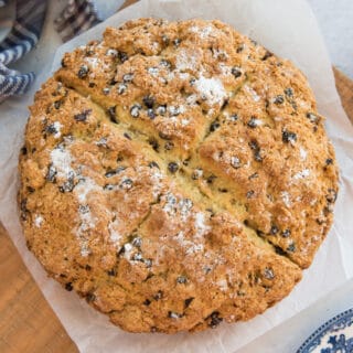 The baked loaf of Irish Soda Bread on a wooden board.