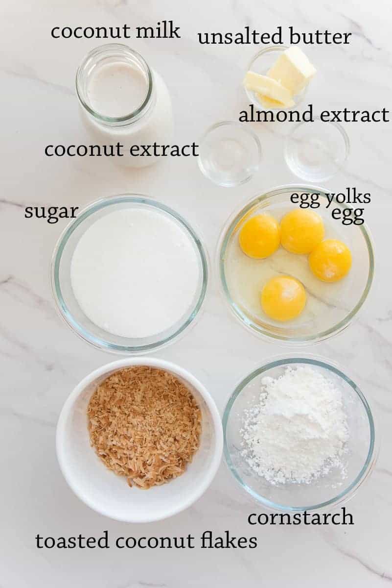 The ingredients to make the custard on a white surface.