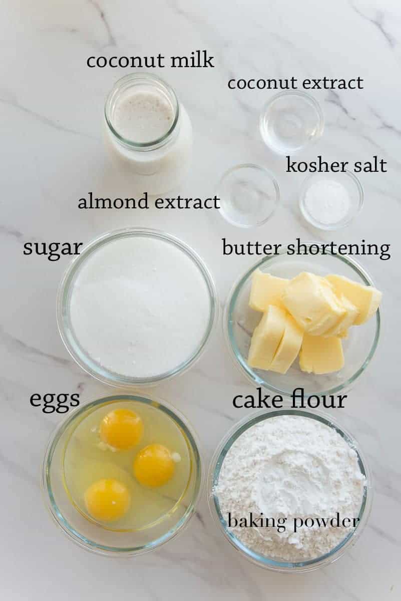 The ingredients to make the Toasted Coconut Cake cake on a white surface.