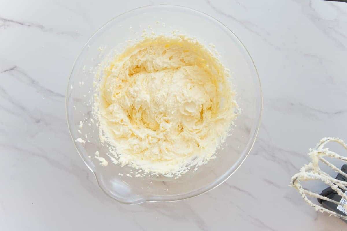 The shortening and sugar and eggs are beaten until light and fluffy in a clear glass mixing bowl.