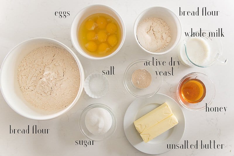 The ingredients to make the Brioche Rolls on a white surface.