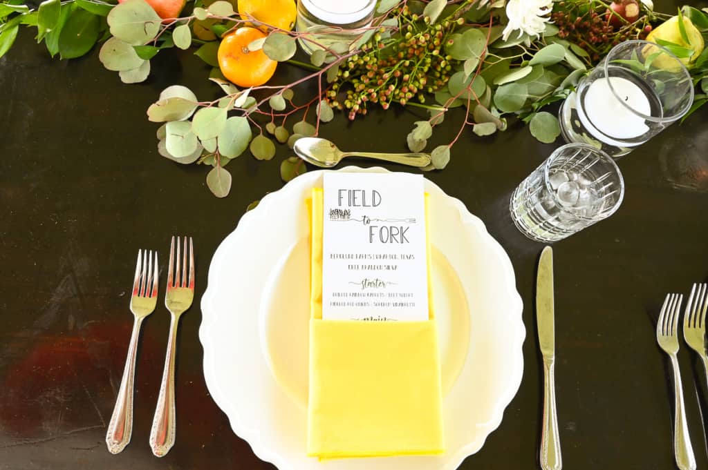White plate with a field to fork menu in a yellow napkin.