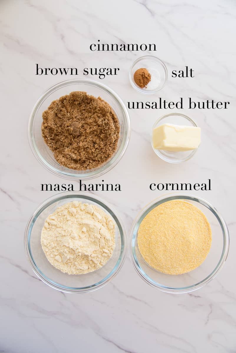 The ingredients to make the cornmeal crumble are on a white countertop.