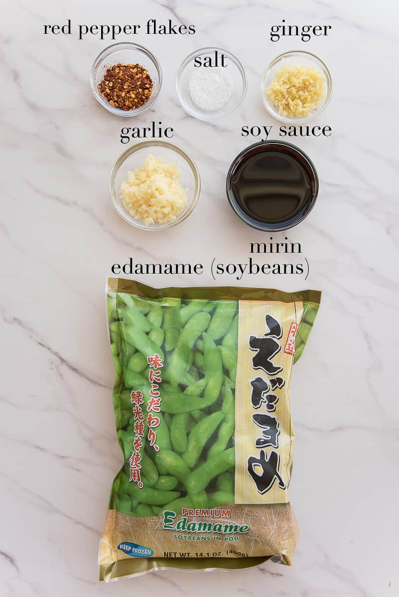 The ingredients needed to make Spicy Garlic Edamame on a white countertop.