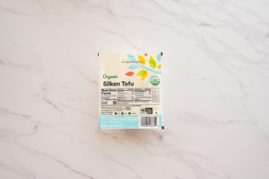 A package of silken tofu on a white surface.
