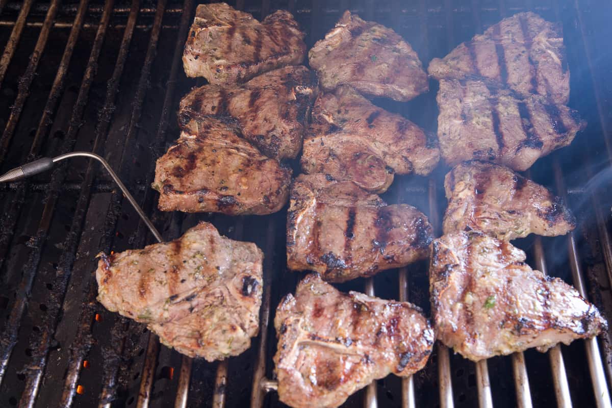 The lamb chops with grill marks on a grill.