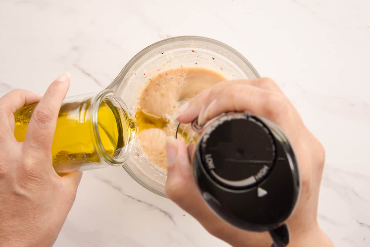 Oil is added to the aromatics with an immersion blender in a glass mixing bowl.
