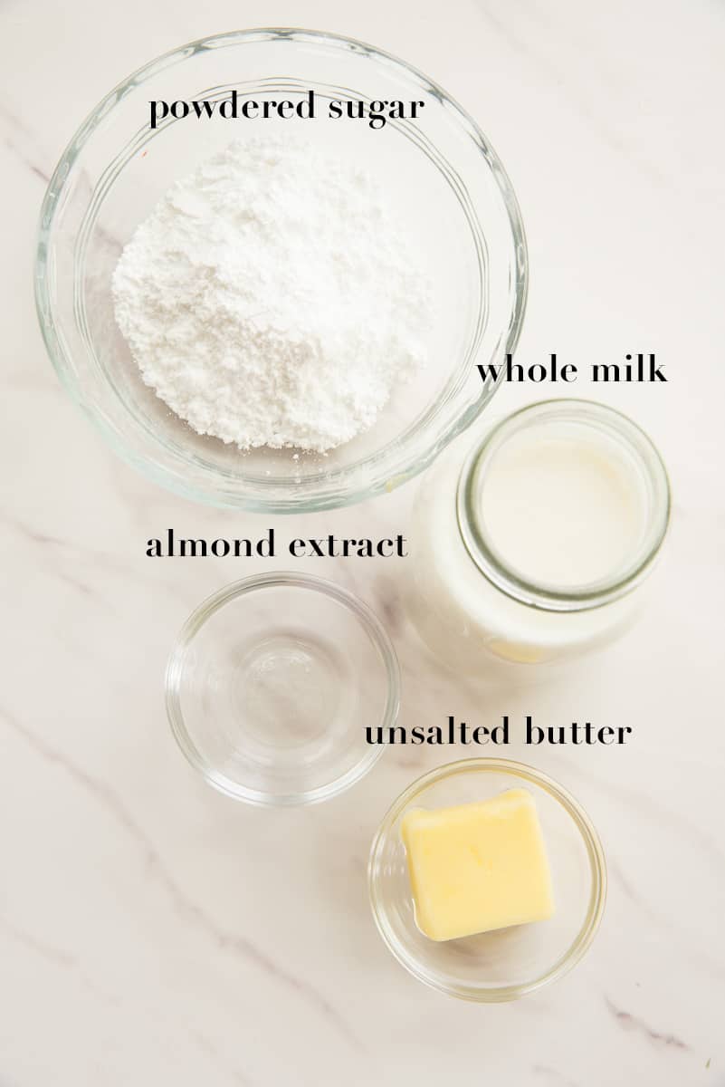 The ingredients needed to make the almond glaze on a white countertop.