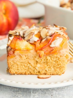 A slice of Nectarine Almond Coffee Cake on a white plate.