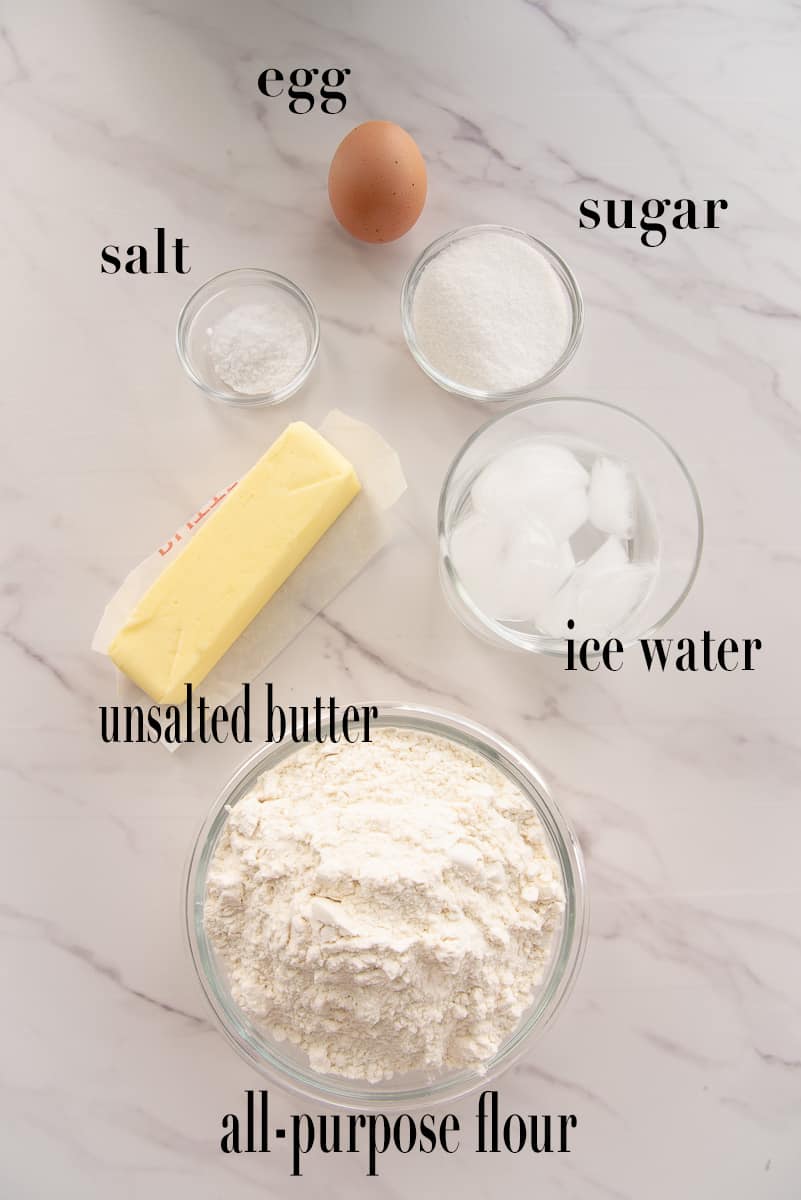 The ingredients to make the dough are labeled and on a white countertop.