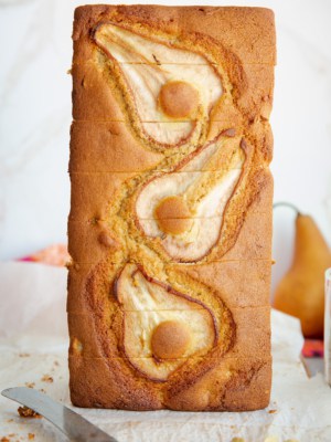 A standing loaf of Pear Cardamom Bread reveals sliced pears on the surface.