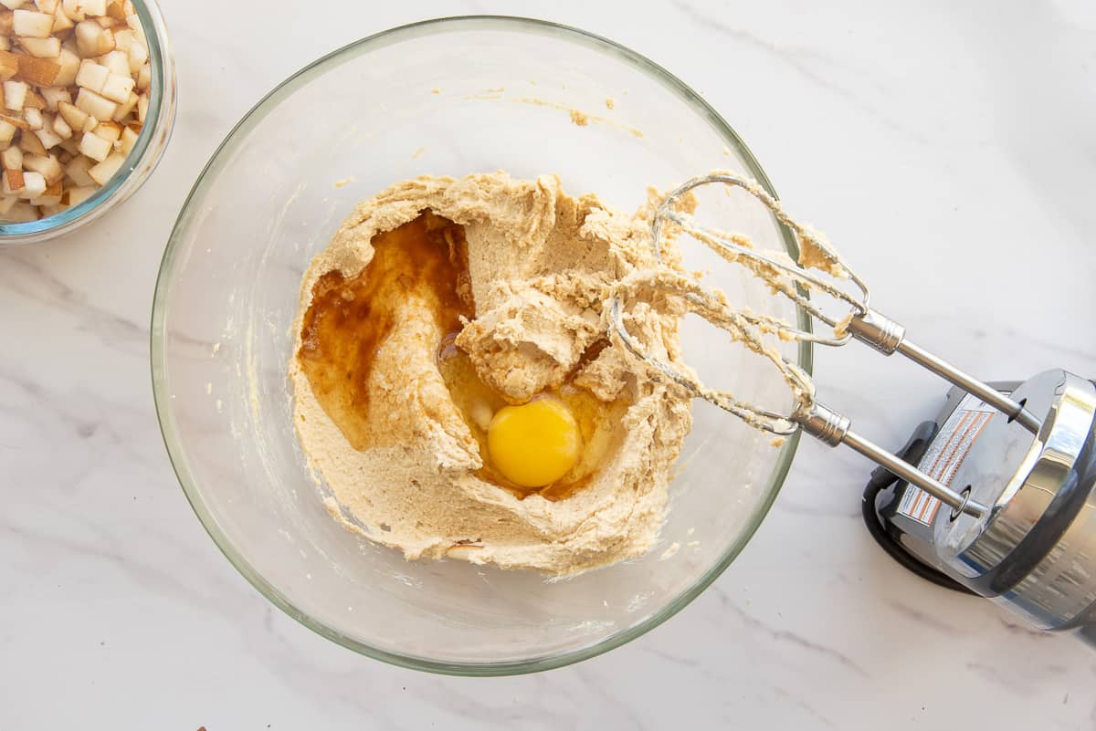 The eggs and extract are added to the bowl with the sugar and butter.