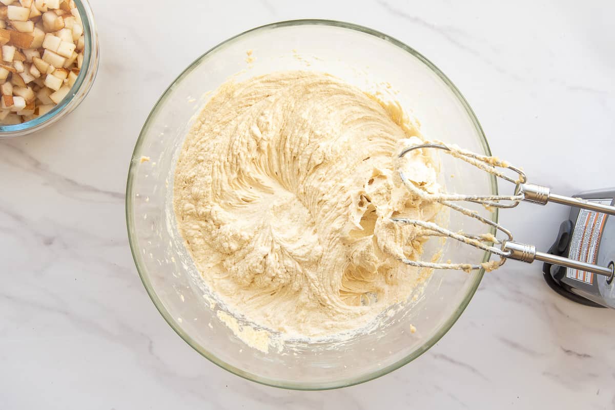 The wet ingredients are beaten with an electric mixer until light and fluffy.