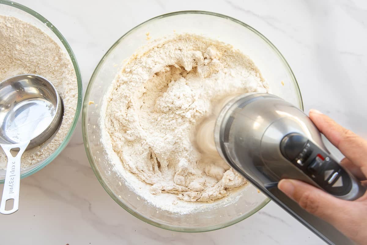 An electric mixer blends the dry ingredients into the wet.