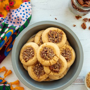 A pie tin filled with Pecan Pie Thumbprint Cookies.
