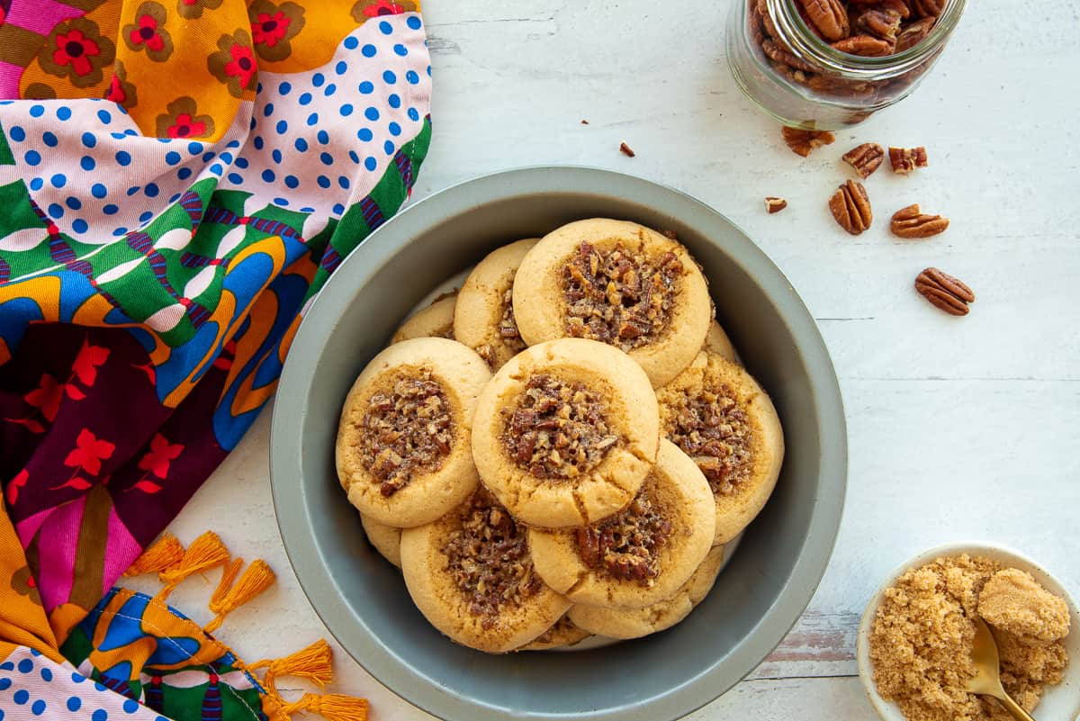 A pie tin filled with Pecan Pie Thumbprint Cookies.