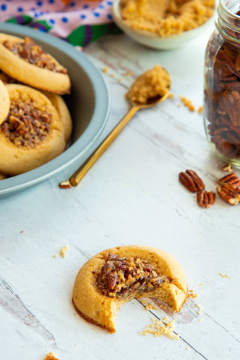 A Pecan Pie Thumbprint Cookies with a bite removed.